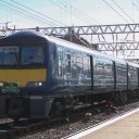 Electric multiple unit glinting in the sunshine with train nameplate The Varamis Express